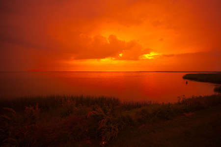 beautiful sunset at a lake IJsselmeer in the netherlandsの写真素材
