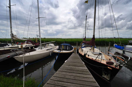 sailboats in a  small Dutch village near Amsterdam in the Netherlands called Durgerdamの写真素材