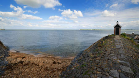 View from the harbor of Volendam a small village in the Netherlands overlooking the lake called IJsselmeerの写真素材