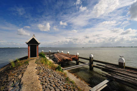 View from the harbor of Volendam a small village in the Netherlands overlooking the lake called IJsselmeerの写真素材