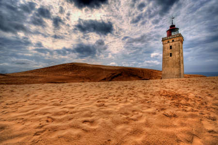 Lighthouse in the sand dunes of Rubjerg Knude in Denmarkの写真素材