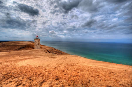 Lighthouse in the sand dunes of Rubjerg Knude in Denmarkの写真素材
