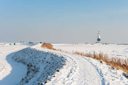 Lighthouse in winter (Marken a small village near Amsterdam)の写真素材