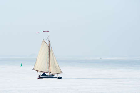 Ice sailing on the frozen lake (gouwzee Between Edam and Marken Netherlands)の写真素材