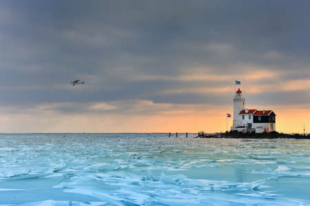 shelf ice and lighthouse in Marken a small village near Amsterdam The Netherlands の写真素材