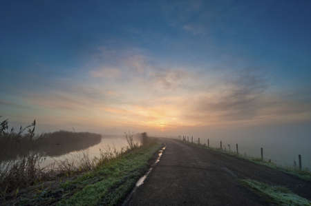 road in the Netherlands on a misty morning, Abcoude, The Netherlandsの写真素材