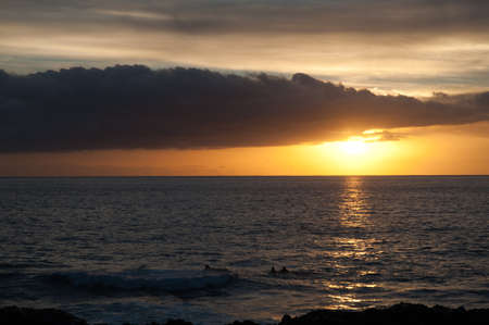 sunset and surfers in El Remo, La Palma, canary islands, spainの写真素材
