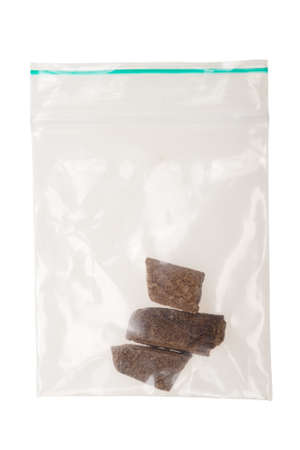 pieces of hashish in a plastic bag , Photo taken with a macro lens,  isolated on a white background
の写真素材