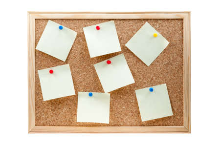 different sticky notes on a cork board isolated on a white backgroundの写真素材
