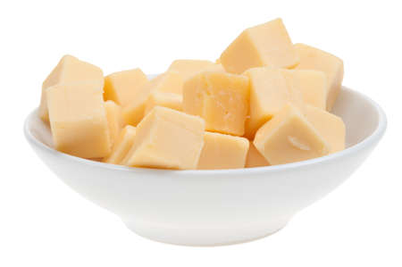 blocks of cheese in a bowl isolated on a white backgroundの写真素材