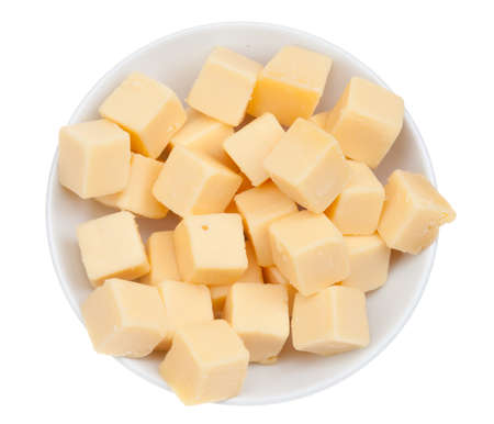 blocks of cheese in a bowl isolated on a white backgroundの写真素材