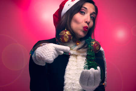 girl with Christmas hat sending a kiss