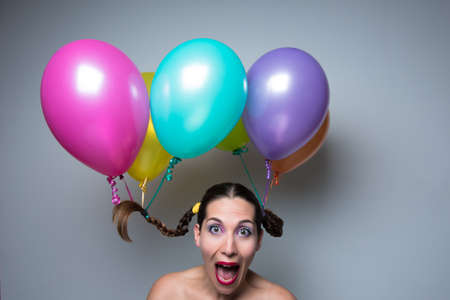 balloons in the head with a surprised girlの写真素材
