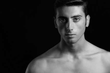 portrait of man in black and white on a black backgroundの写真素材