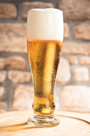 pint of beer on wooden plan with rustic backgroundの写真素材