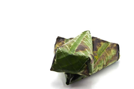 Sticky rice roast  , wrapped in banana leaves and white background の写真素材