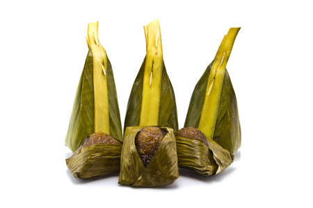 Thai dessert, Sticky rice with manioc, wrapped in banana leaves の写真素材