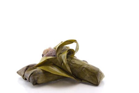 Thai dessert, Sticky rice with banana fruit, wrapped in banana leaves の写真素材