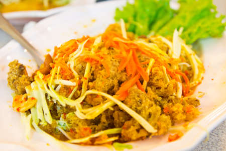 Spicy fried Thai tilapia fish salad minced meat with vegetable,thai foodの写真素材