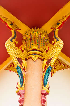 golden bird pattern decorative roof suspension of thai templeの写真素材