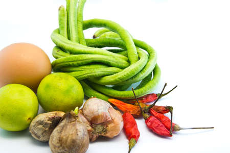Red onion chilli lemon egg and long beans selection of ingredients used in Asian cookingの写真素材