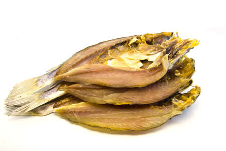 three dry medium fishes on a white backgroundの写真素材