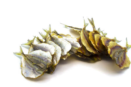 many dry small fishes on a white backgroundの写真素材