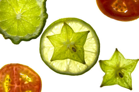 Slices of Star fruit,tomatoes, lemon, and Bergamot on white background の写真素材