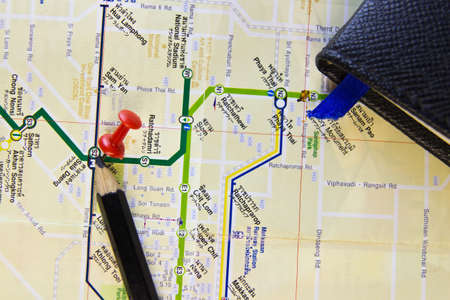 Several push pins on a road-map of a tourist to train in Bangkok,Thailandの写真素材
