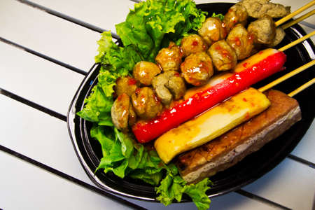 group meatballs in chili sauce in black dish on wood white  の写真素材