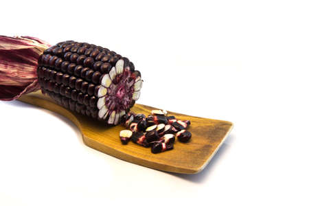 fresh corn on brown wood on white background の写真素材