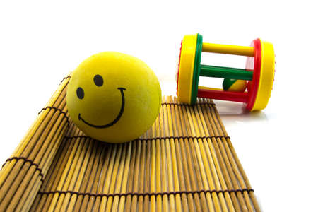 happy smiley yellow  ball on wood concept isolated on white の写真素材