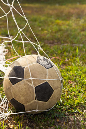 old  ball in goal in fieldの写真素材