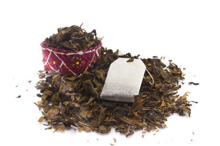 tea bags over dried tea leaves backgroundの写真素材