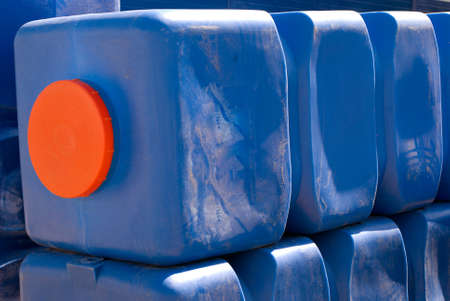 Row of blue plastic water tanks at sunny dayの写真素材