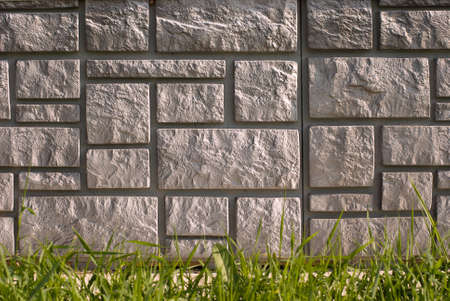 Texture of stone house foundation with green grass outdoorsの写真素材
