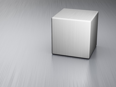 Metal cube on brushed steel plateの写真素材