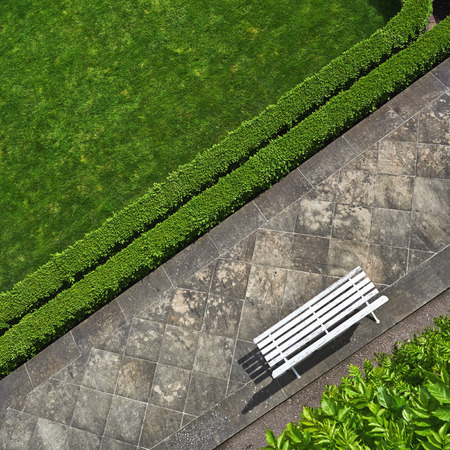 Geometric background with a white bench in a green park. Top viewの写真素材
