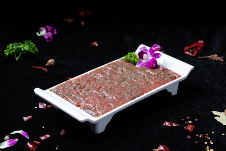 beef tartare with herbs on a black background. tinting. selective focusの写真素材