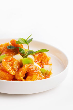 Stir-fried chicken with sweet and sour sauce on white backgroundの写真素材