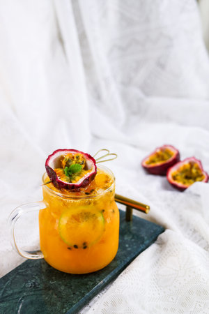 Passion fruit smoothie with passion fruit and mint in a glass jar.の写真素材