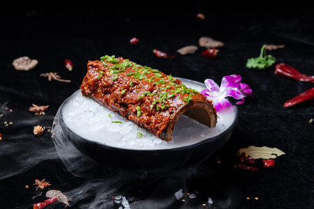 Korean traditional food simmered pork belly on a black backgroundの写真素材