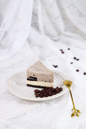 Piece of chocolate cake with coffee beans on a white background.の写真素材