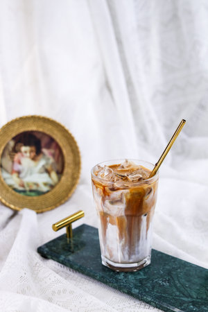 Iced coffee with milk in a glass on a white background.の写真素材
