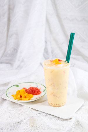 Milkshake with mango and grapefruit on a white background.の写真素材