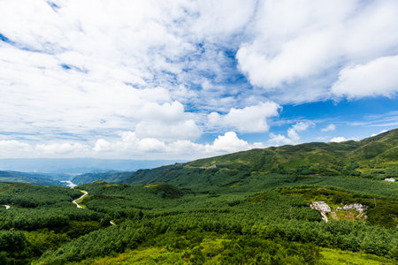 Beautiful green mountains under blue sky with white clouds in summer.の写真素材