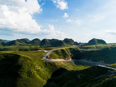 Aerial view of mountain and road with blue sky in the morningの写真素材