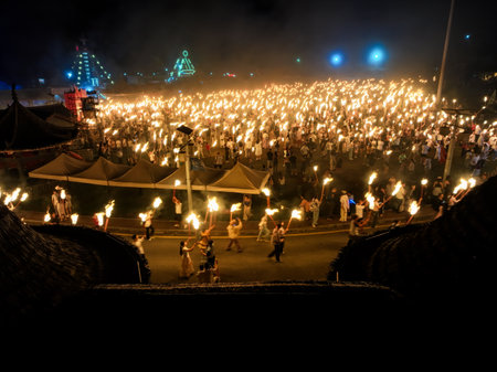 Unidentified people with burning torches at a temple in Bangkok, Thailand.の写真素材