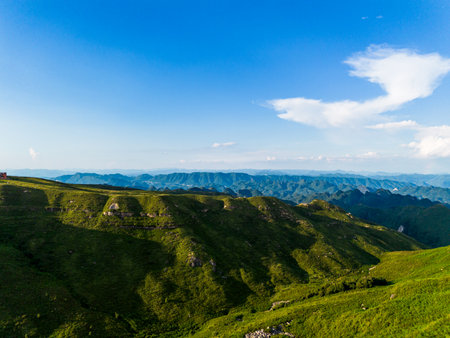 Mountain landscape scenery view with clear blue sky and white clouds.の写真素材