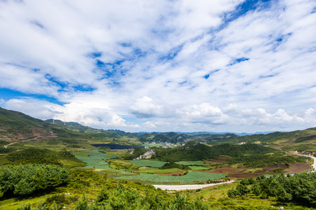 Mountain landscape with blue sky and white clouds.の写真素材